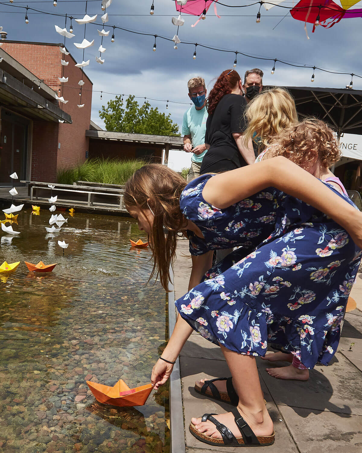 Young children playing in the pond at the Studio Theatre